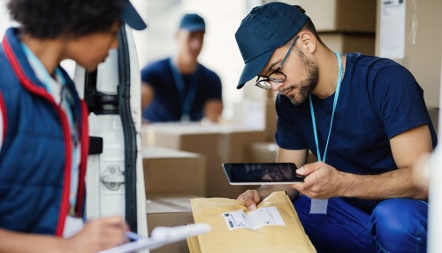 Omnichannel fulfillment services with warehouse staff scanning packages using digital technology